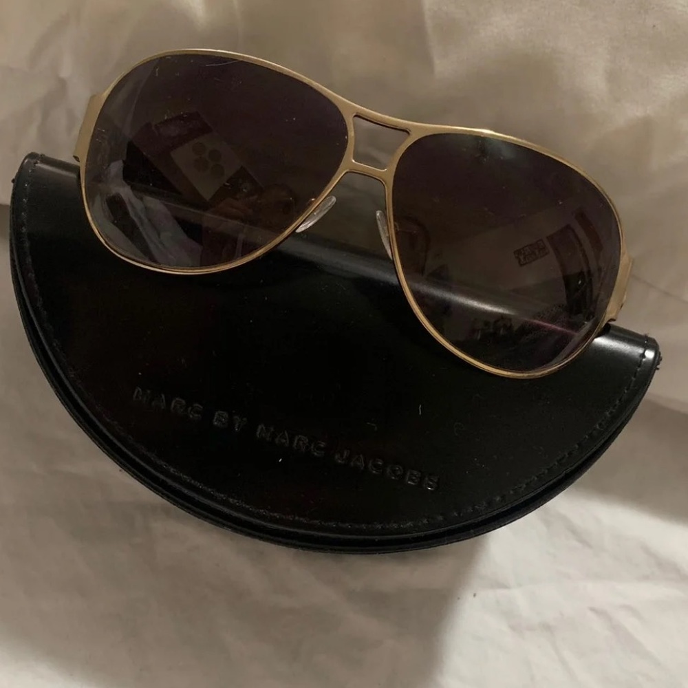 Woman gold aviator sunglasses.